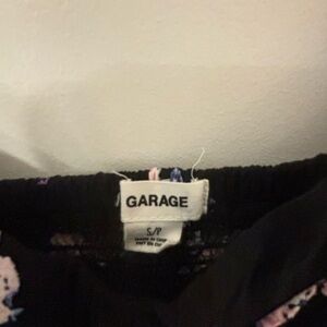 black dress with floral print from brand Garage.